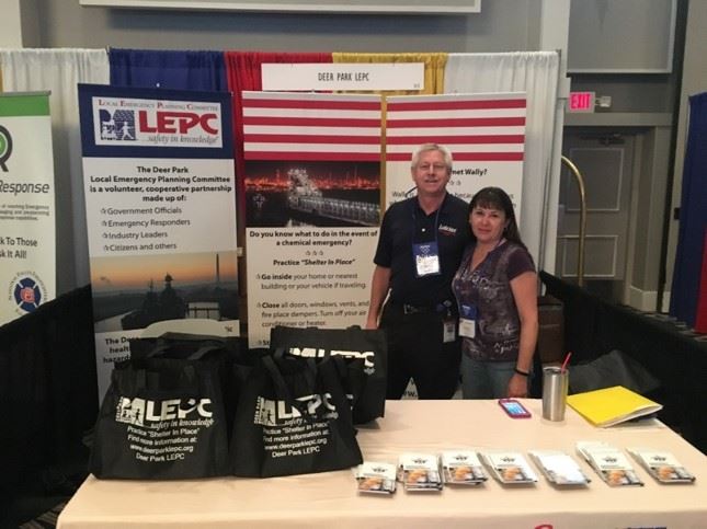 Man and women standing at a LEPC booth during an event